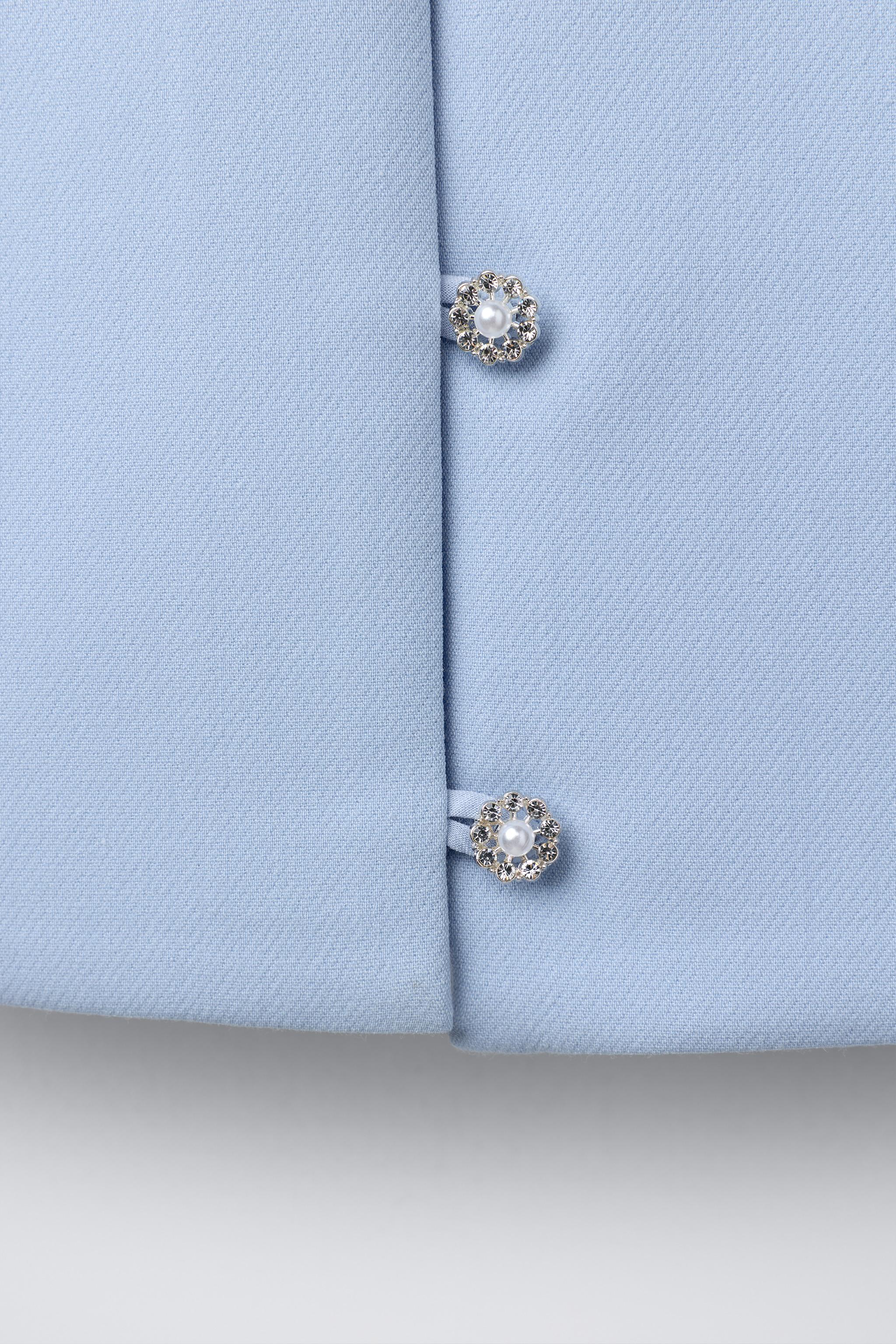 TOP AVEC BOUTON BIJOU